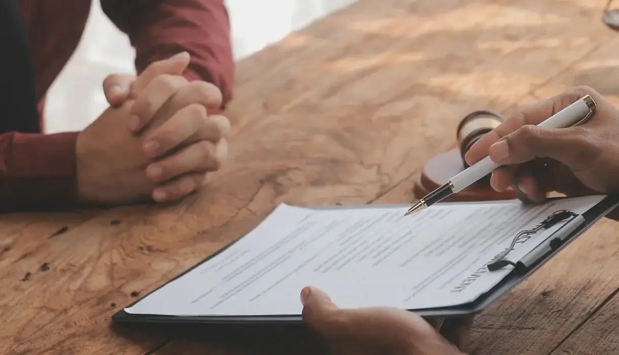 Legal counsel presenting a signed contract to a client
