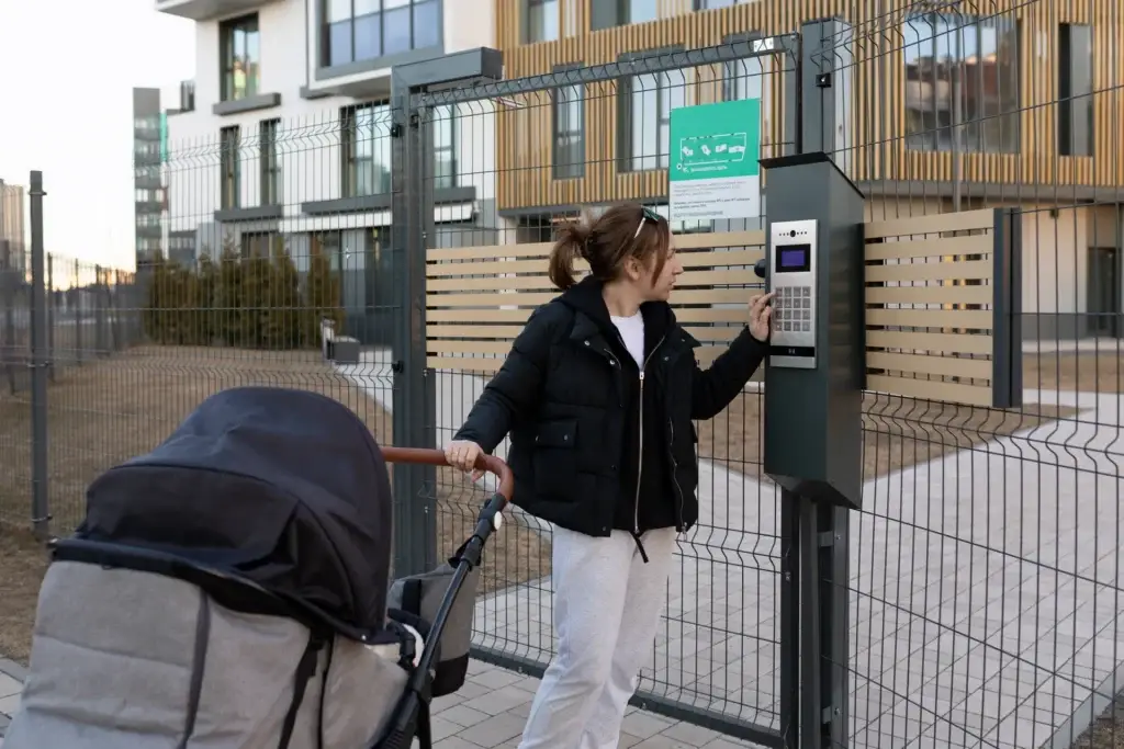 Mother with a stroller entering a secure residential yard